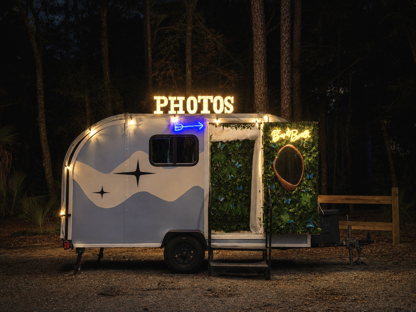 The Something Blue camper photo booth lit up at night