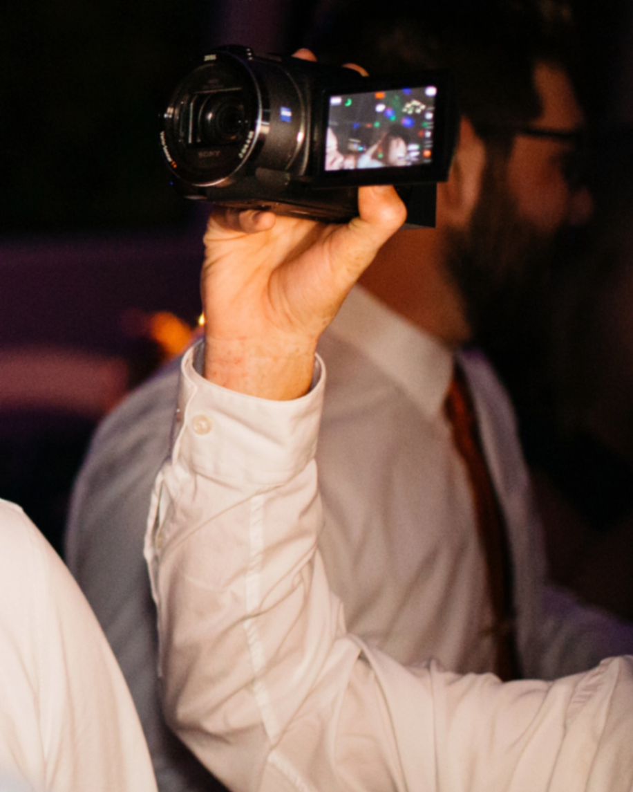 Guest filming a reception with a handheld camcorder