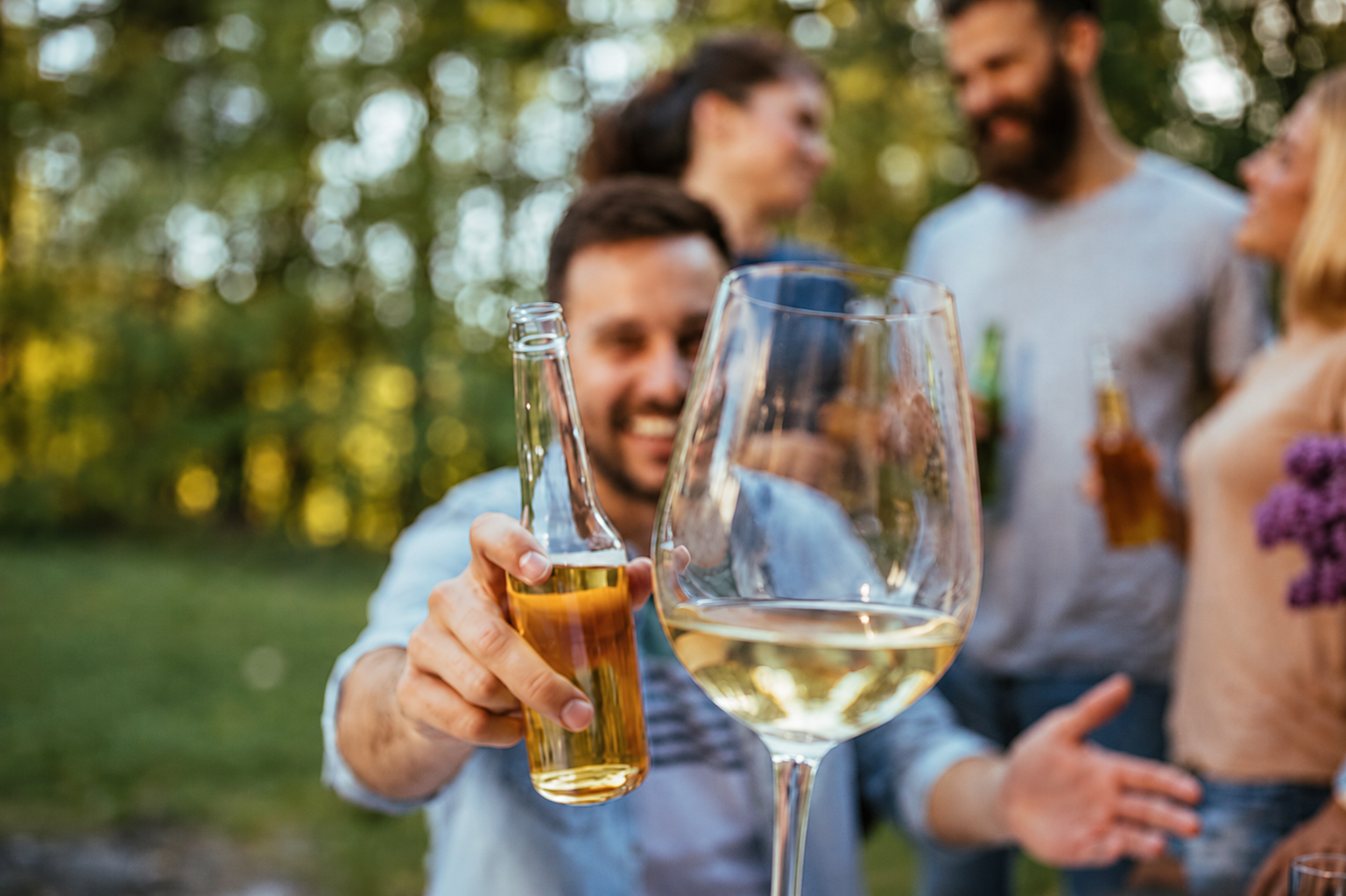 Guests toasting with a glass of wine in the foreground