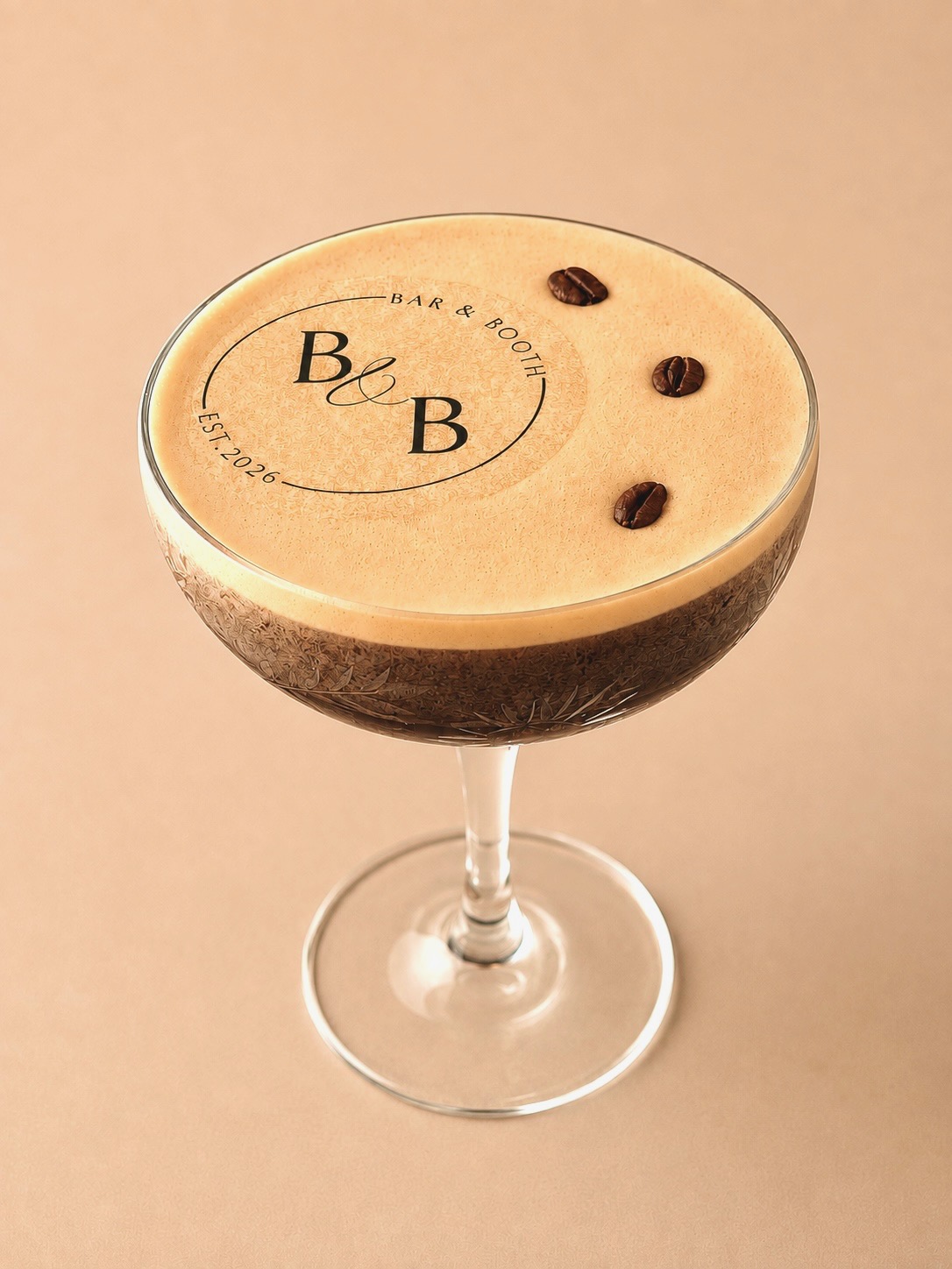 Espresso Martini topped with foam and three espresso beans