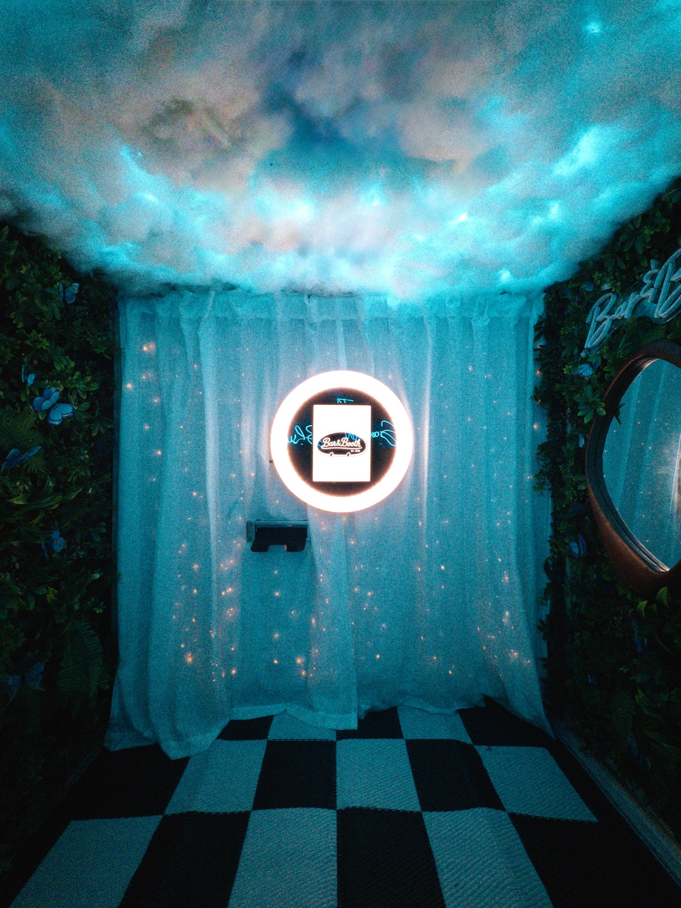 Interior of the camper photo booth with cloud ceiling and ring light