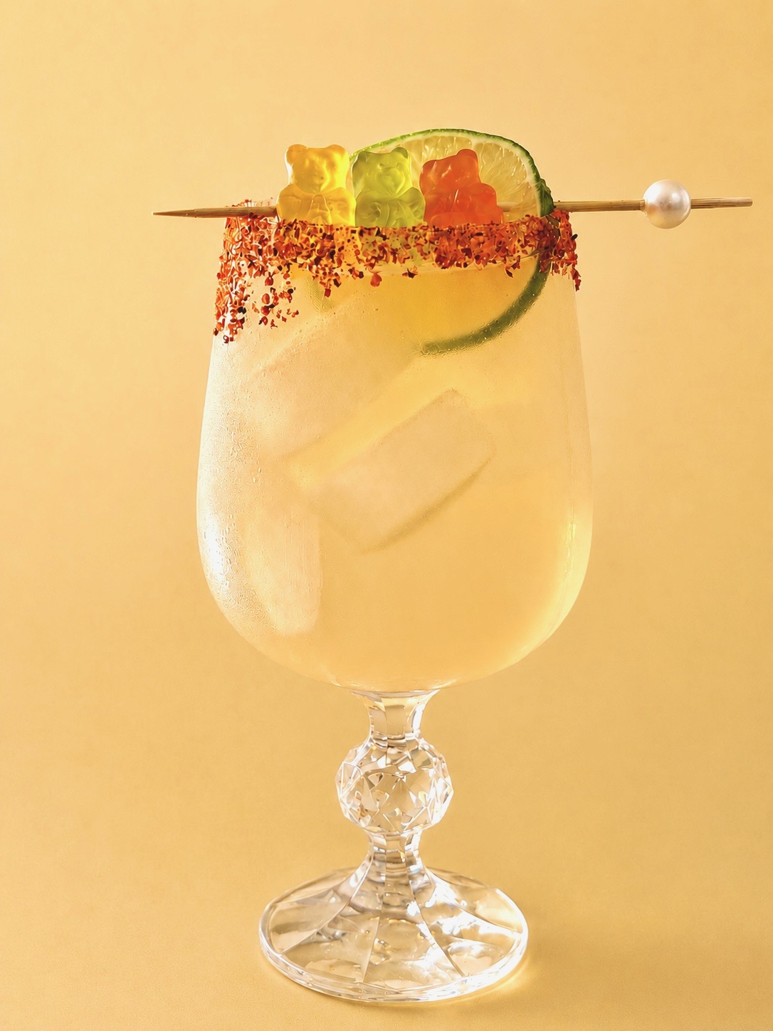 The Goldilocks Margarita with a tajín rim, lime wheel and three gummy bears