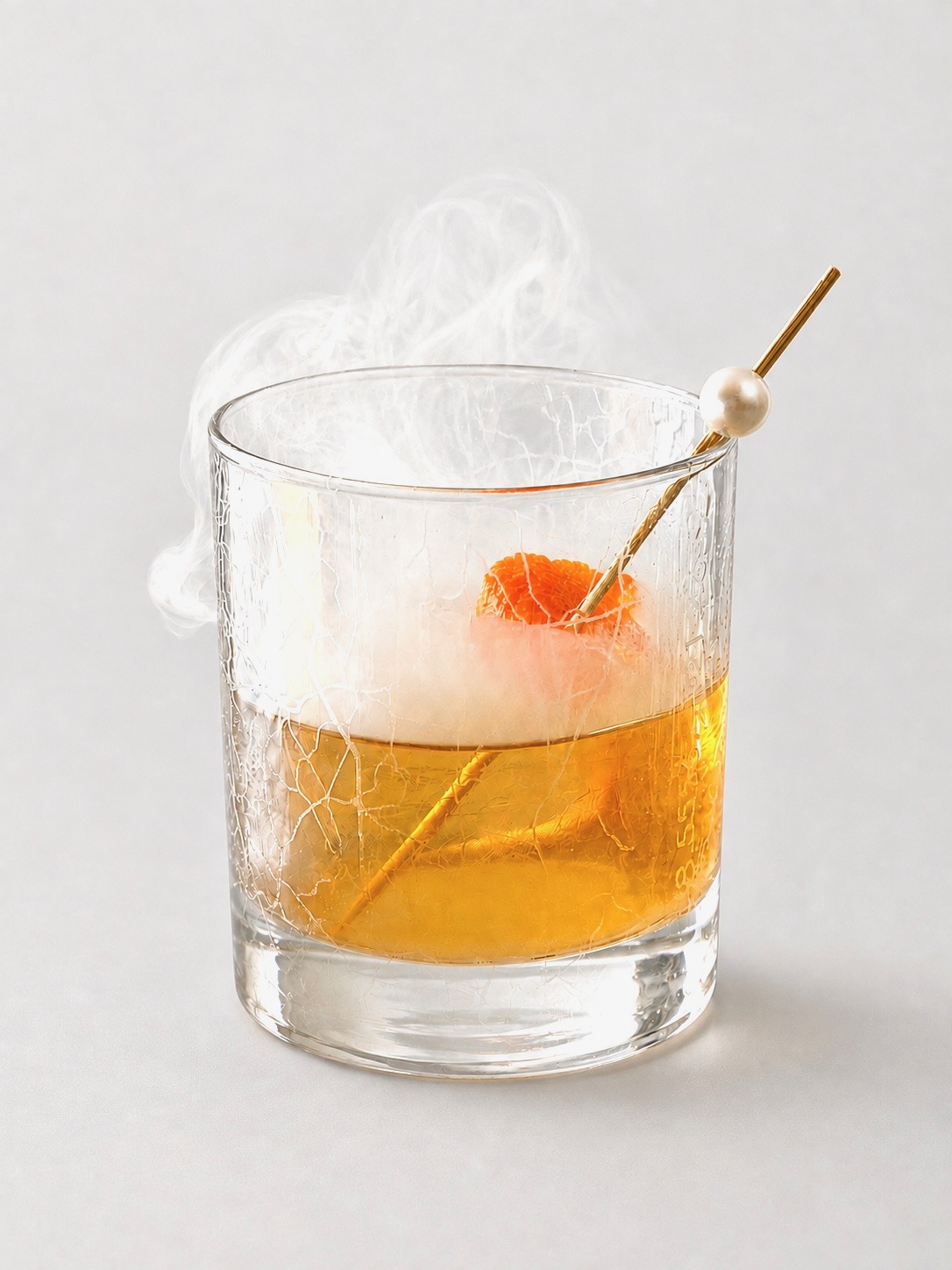 The Smoked Old Fashioned in a crystal glass with a large ice cube, orange peel, and smoke infusion