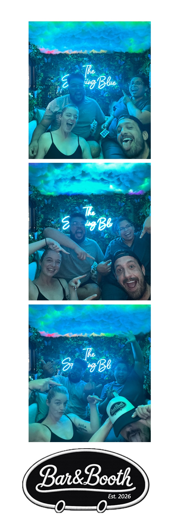 Friends posing under the neon Something Blue sign